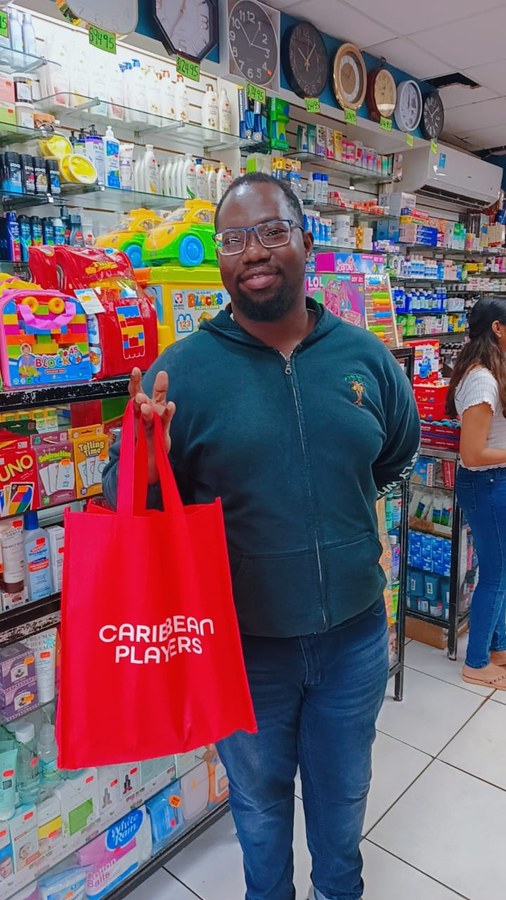 Customer with Caribbean Players gift bag